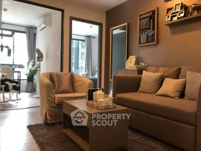 Cozy living room with modern decor and natural light in a stylish apartment.