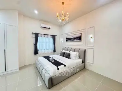 Luxurious modern bedroom with elegant chandelier and stylish decor