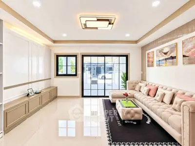 Spacious modern living room with elegant decor and large windows for natural light.