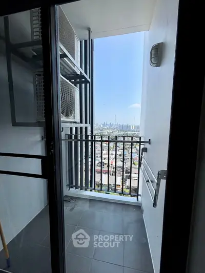 Compact balcony with city skyline view from high-rise apartment