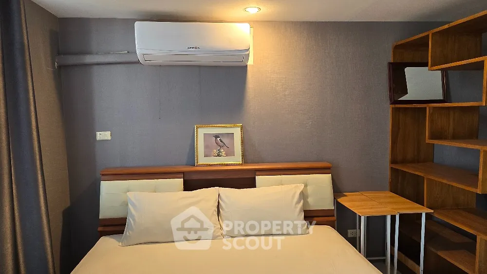 Modern bedroom with air conditioning and stylish wooden shelving