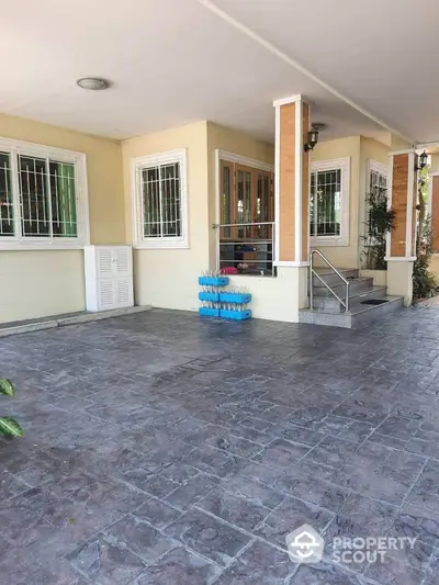 Charming entrance with spacious patio and secure windows in a cozy residential property.