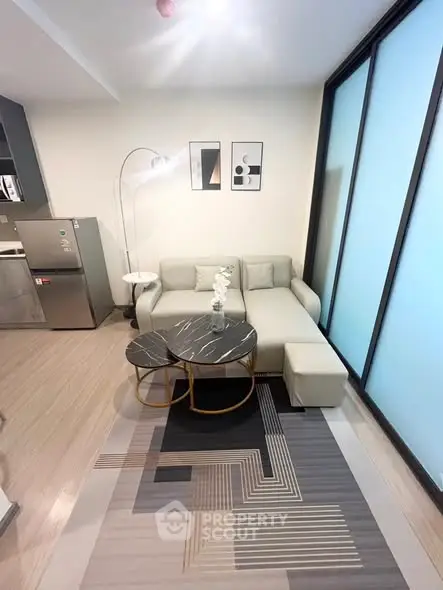 Modern living room with stylish furniture and natural light, featuring a cozy sofa and chic decor.