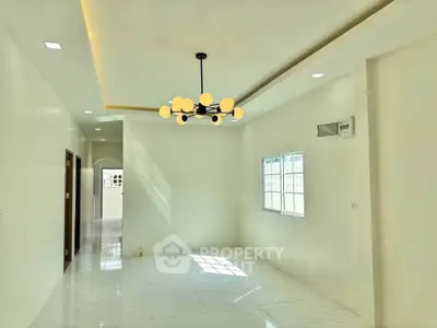 Bright modern living room with elegant lighting and large window