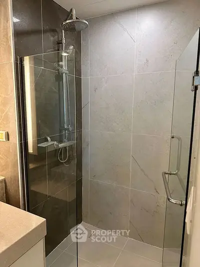 Modern bathroom with sleek glass shower and elegant tile design