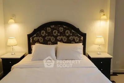 Elegant bedroom with plush headboard and ambient lighting