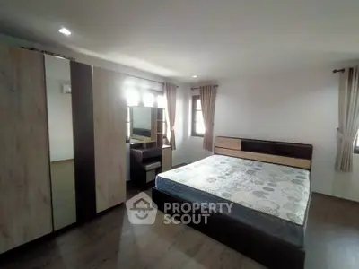 Spacious bedroom with modern furnishings and ample natural light