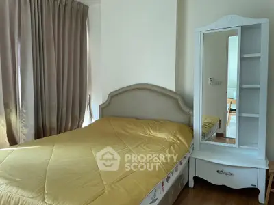 Cozy bedroom with elegant mirror and soft lighting, perfect for relaxation and comfort.