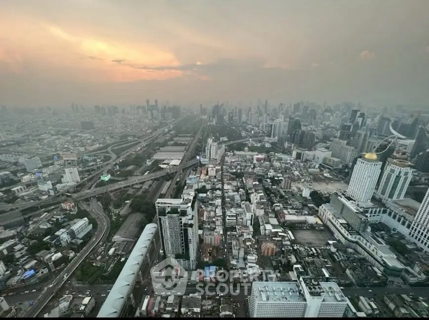 Stunning cityscape view from high-rise building at sunset, showcasing urban skyline and vibrant city life.