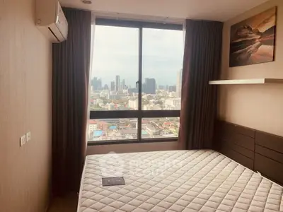 Modern bedroom with city view, featuring large window and stylish decor in urban apartment.