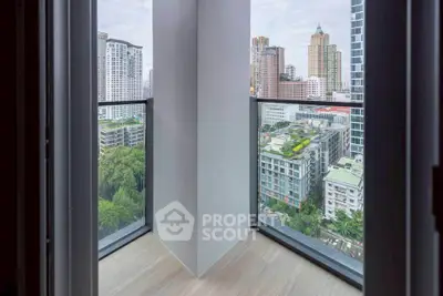 Stunning city view from a modern high-rise balcony with glass railings.