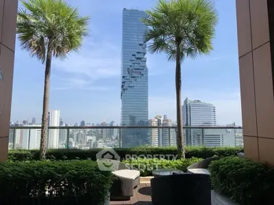 Stunning cityscape view from a lush balcony with modern seating area.