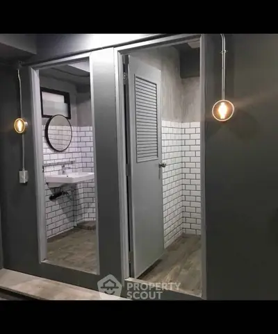 Modern bathroom with subway tiles and stylish lighting