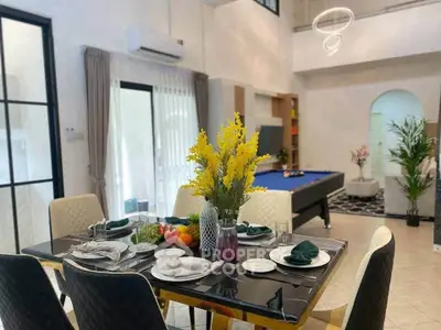 Elegant dining area with modern decor and pool table in spacious living room