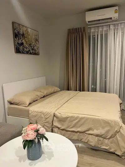 Cozy bedroom with elegant decor and natural light, featuring a comfortable bed and stylish curtains.