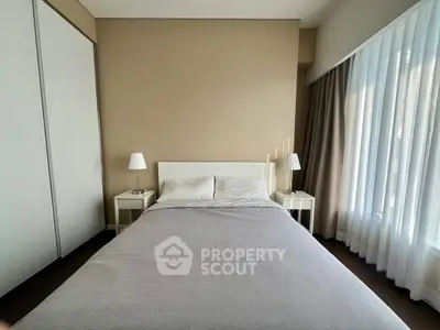 Cozy bedroom with modern decor and ample natural light