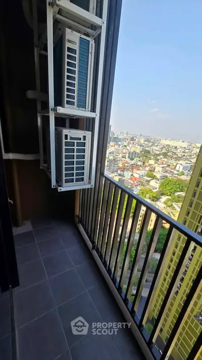 High-rise balcony with cityscape view and air conditioning units