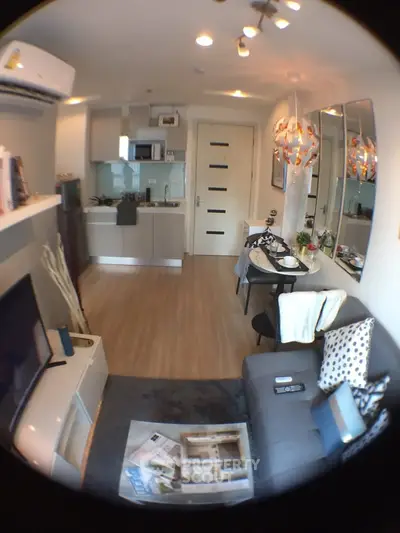 Modern open-plan living room with stylish decor and compact kitchen area