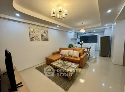 Modern open-layout living room with stylish furniture and elegant lighting