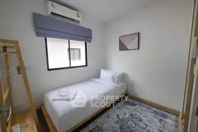 Cozy bedroom with single bed, air conditioning, and modern decor in a minimalist style.