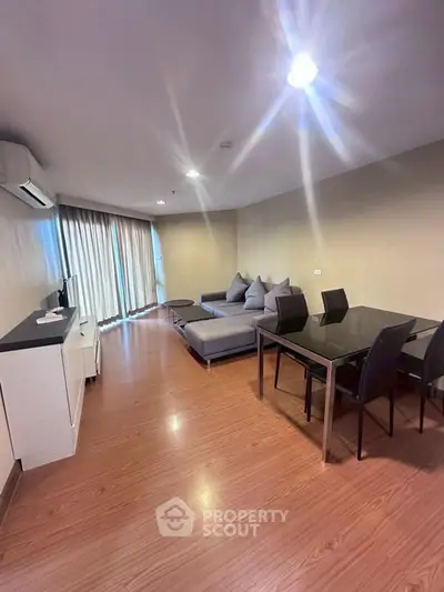 Spacious modern living room with sleek furniture and large windows for natural light.