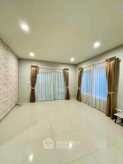 Spacious empty living room with elegant curtains and tiled flooring