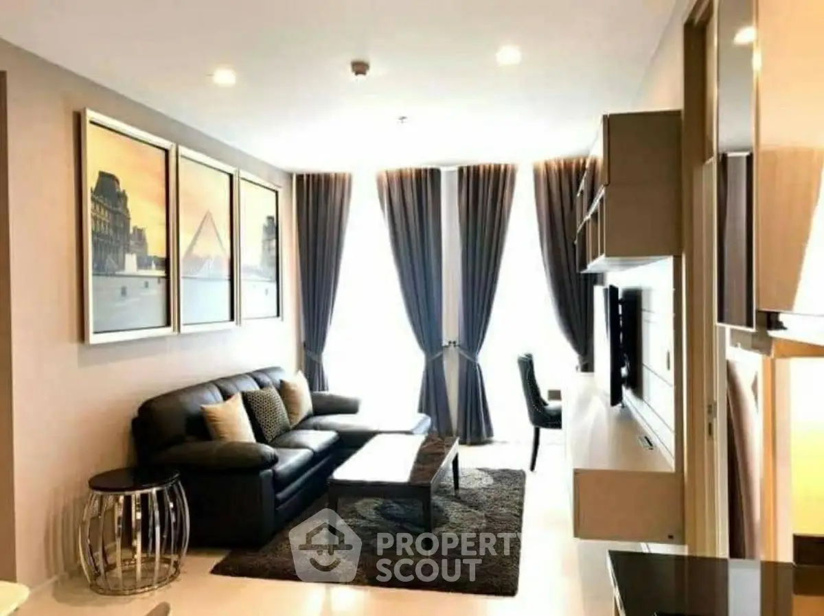 Modern living room with stylish decor and large windows in a contemporary apartment.