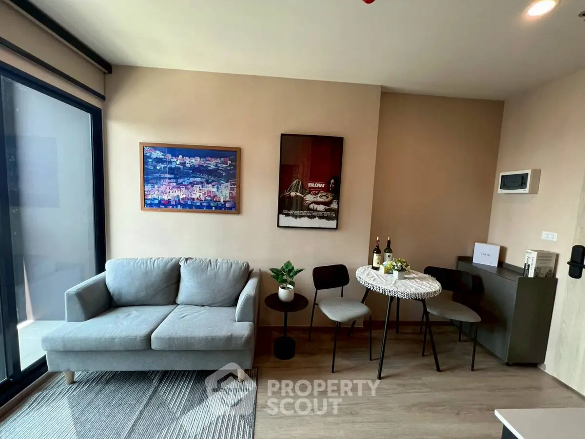 Modern living room with cozy sofa, stylish decor, and dining area in a chic apartment.