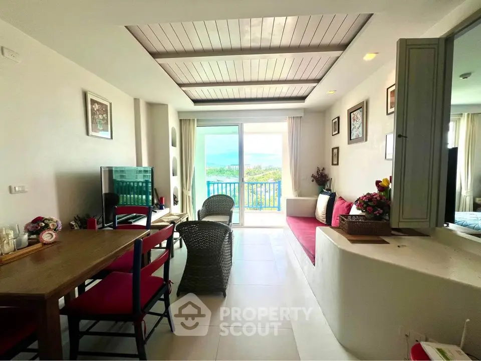 Charming living room with ocean view, cozy seating, and elegant decor in a beachfront property.