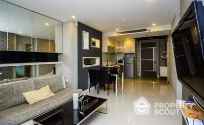 Modern apartment interior featuring an open layout with a sleek kitchen, stainless steel appliances, and a cozy living area with contemporary furnishings.