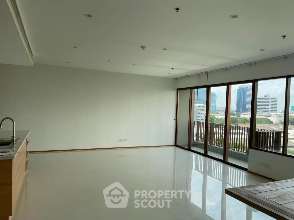 Spacious modern living room with large windows and city view