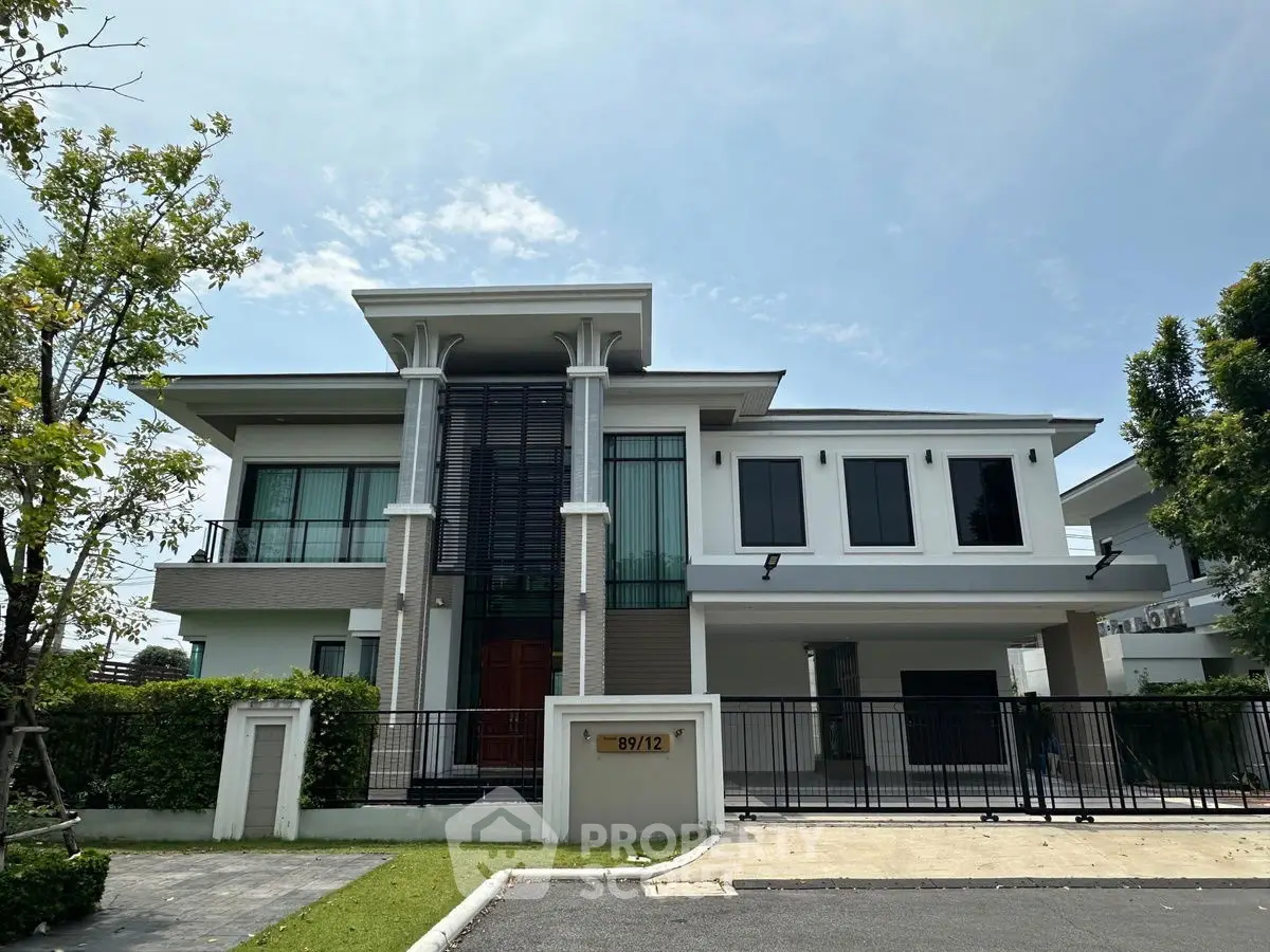 Modern two-story house with sleek design and spacious driveway in a serene neighborhood.