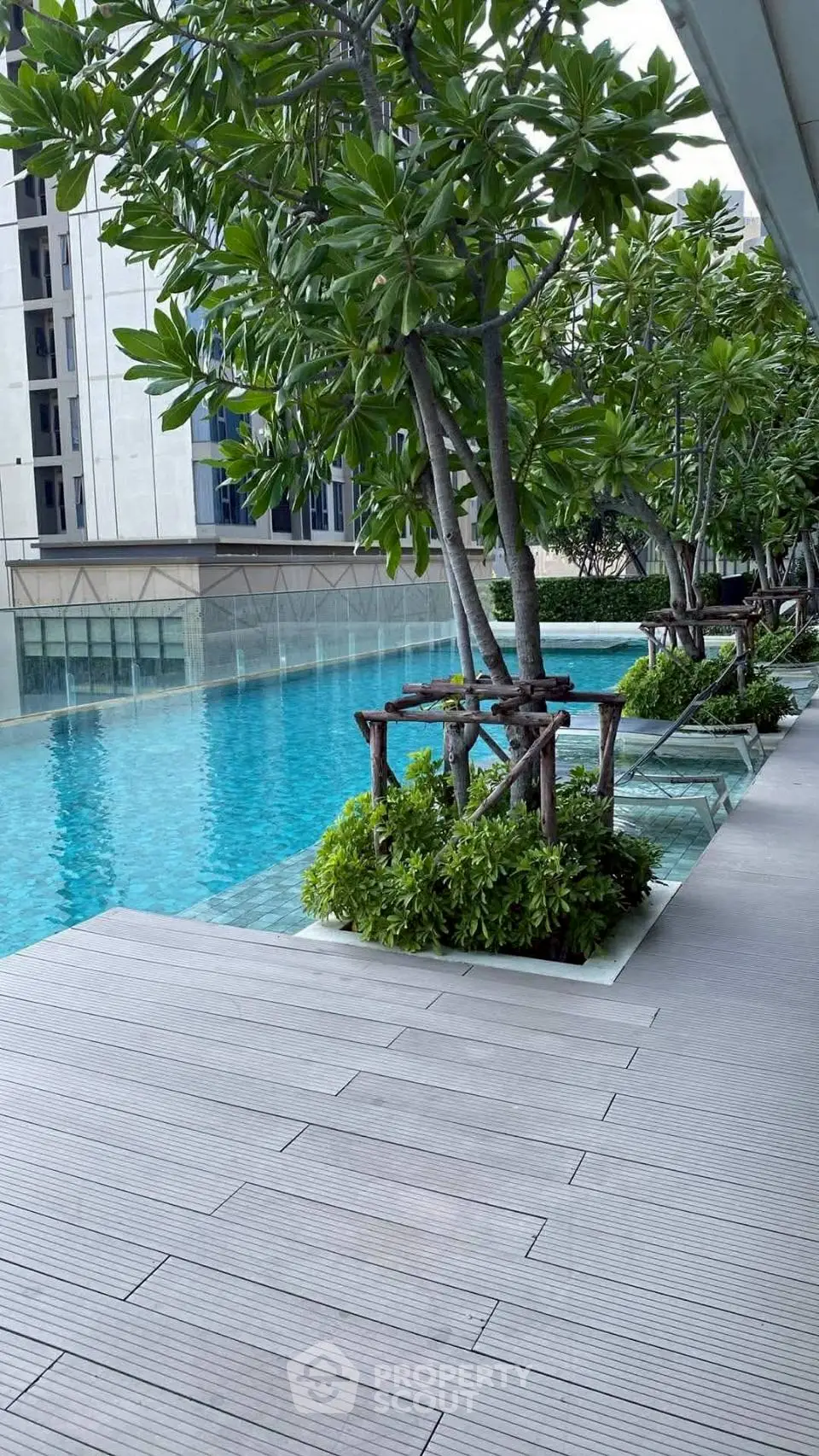 Luxurious apartment complex with stunning poolside view and lush greenery