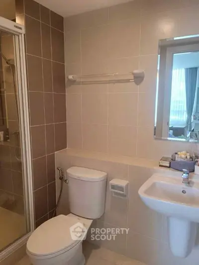 Modern bathroom with shower and sleek fixtures in a contemporary apartment.