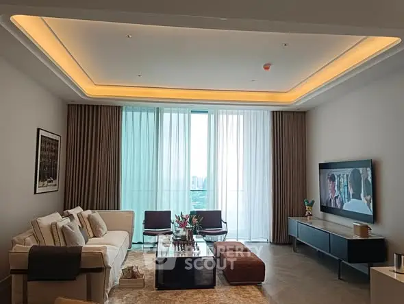 Luxurious living room with modern decor and large windows offering city views.