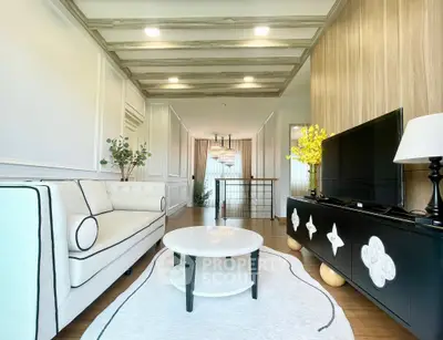 Stylish living room with modern decor and elegant lighting, featuring a cozy sofa and sleek TV unit.