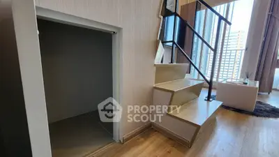 Modern duplex apartment with stylish staircase and city view, featuring elegant wooden flooring and ample natural light.