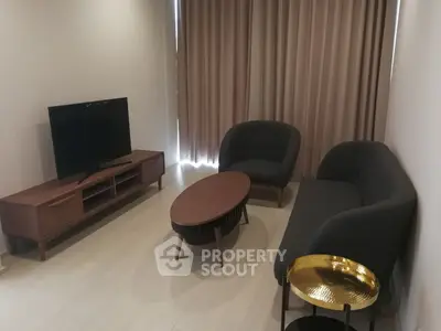 Modern living room with stylish furniture and flat-screen TV, perfect for relaxation and entertainment.