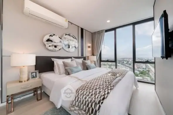 Luxurious bedroom with panoramic city view and elegant decor