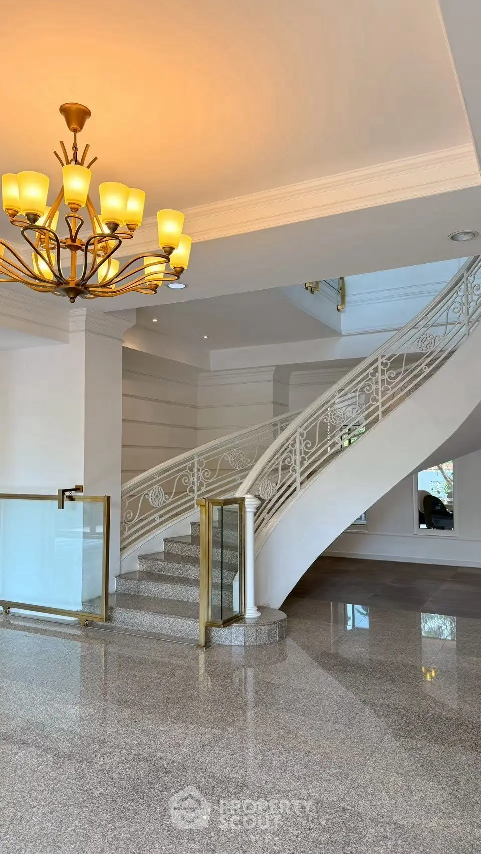 Elegant staircase with chandelier in luxurious building lobby