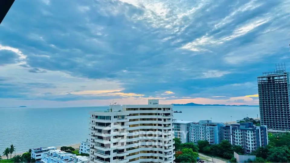 Stunning ocean view from high-rise building with expansive skyline and serene sea horizon.
