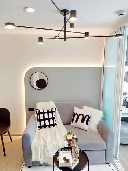 Modern living room with stylish decor and cozy seating area, featuring contemporary lighting and chic accents.