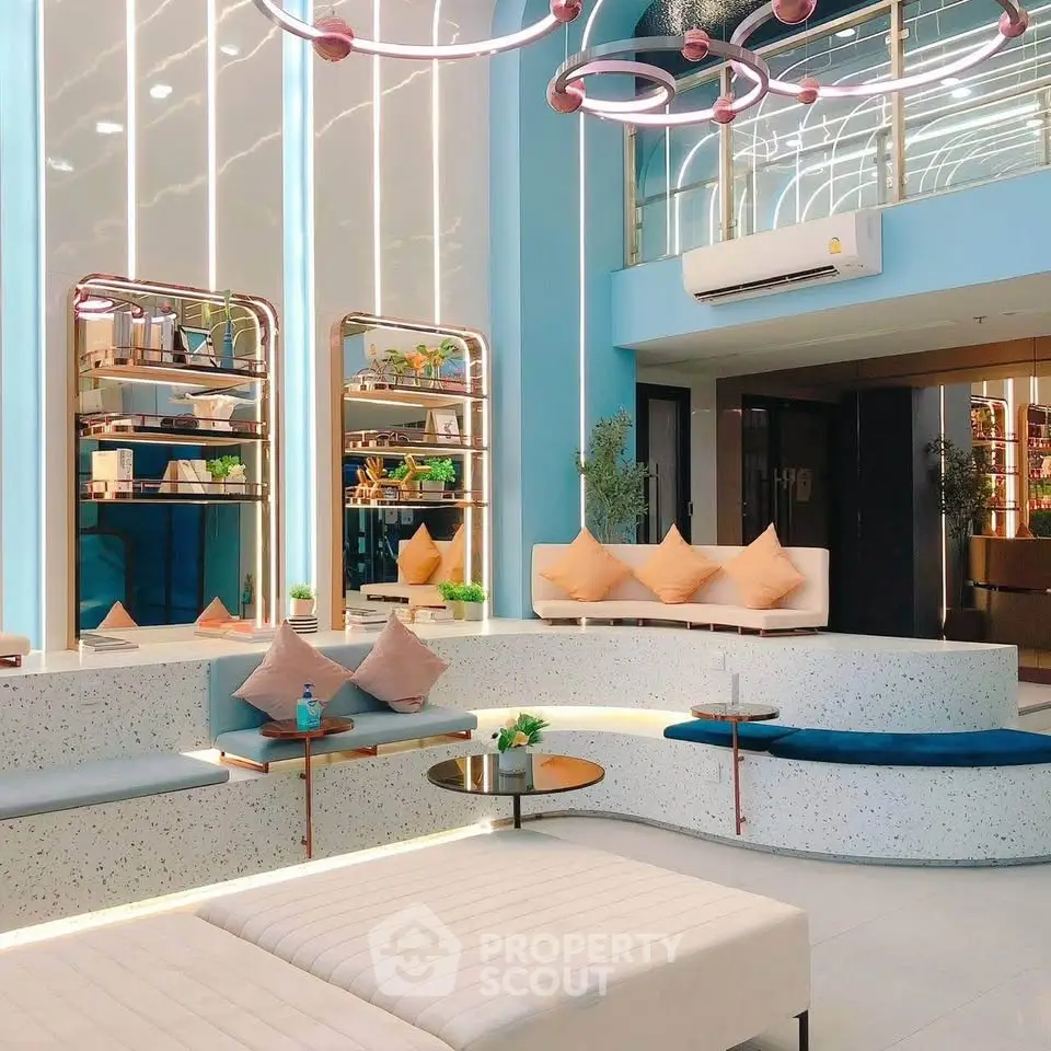 Modern lobby with stylish seating and contemporary lighting in a luxury building.