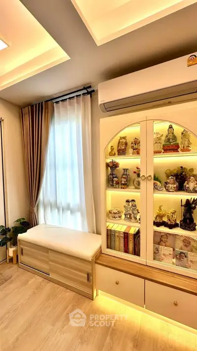 Elegant living room with illuminated display cabinet and modern decor