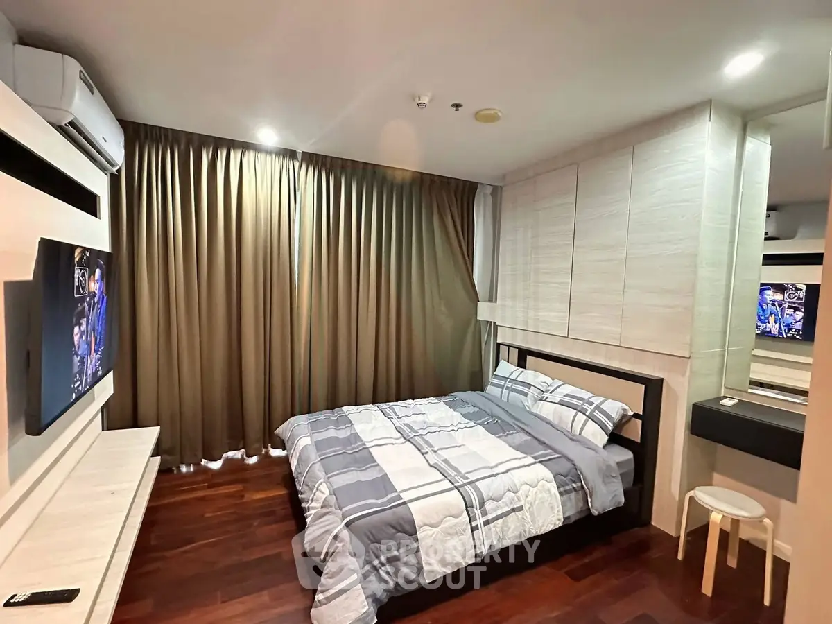Modern bedroom with stylish decor and wooden flooring in a cozy apartment.