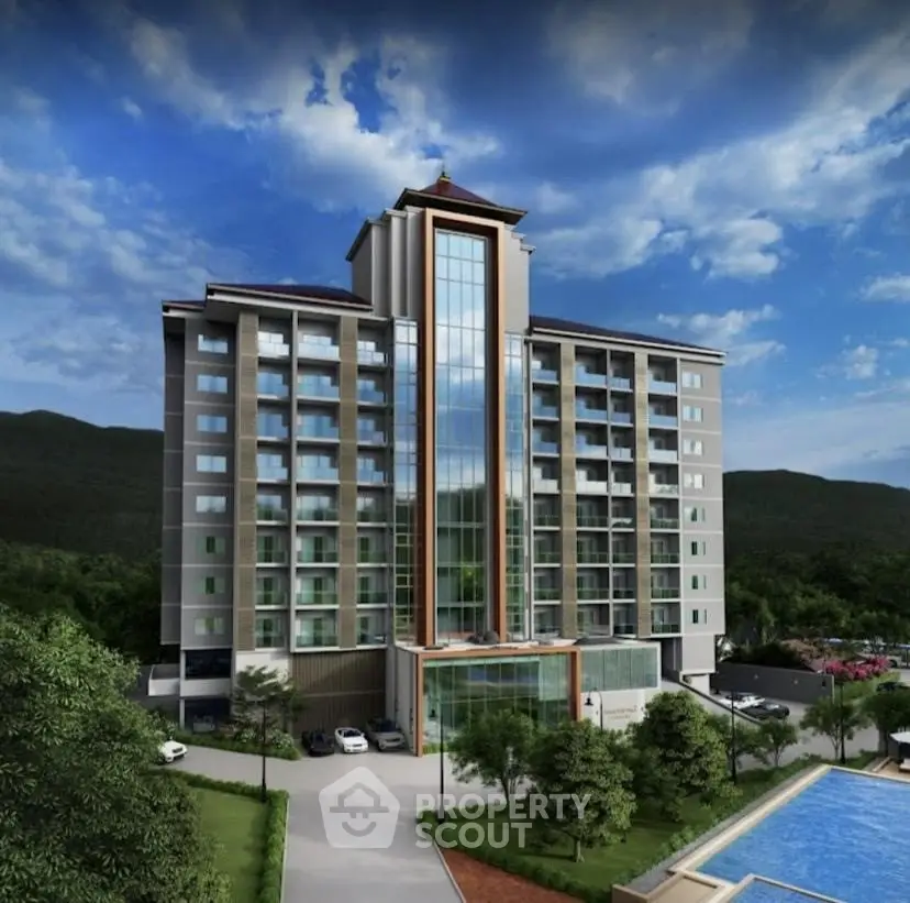 Stunning modern apartment building with pool and scenic mountain backdrop.