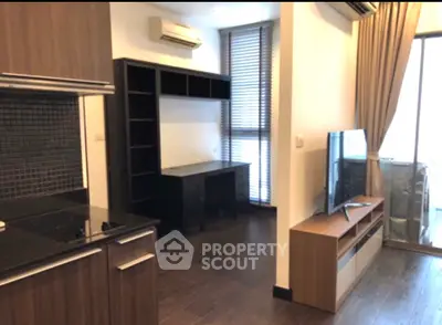 Modern living room with sleek kitchen and stylish furniture