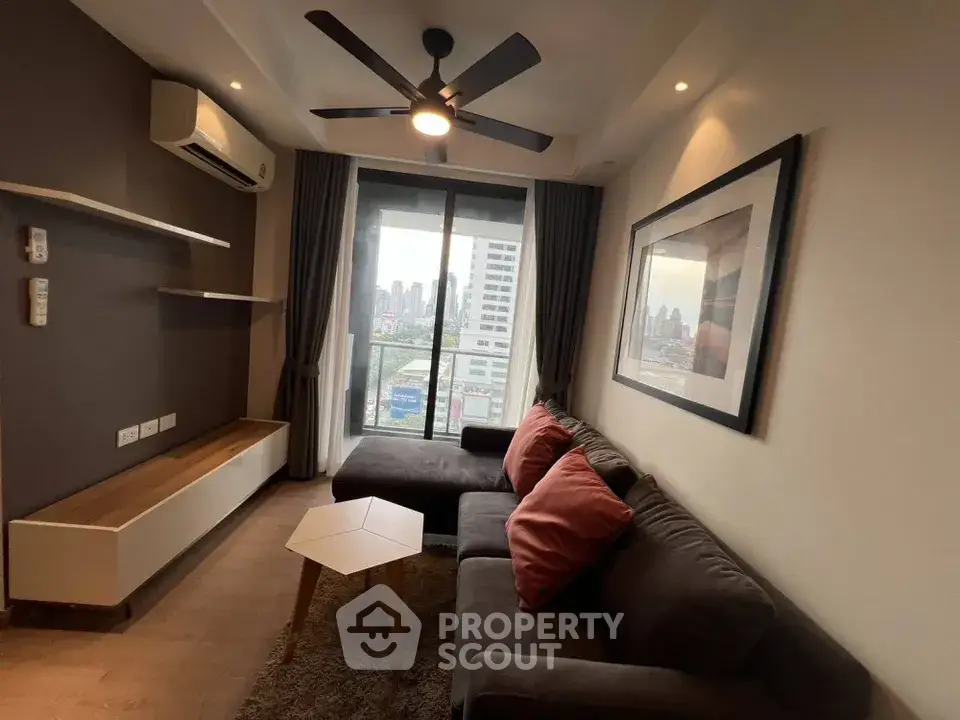 Modern living room with city view, featuring cozy sofa and stylish decor.