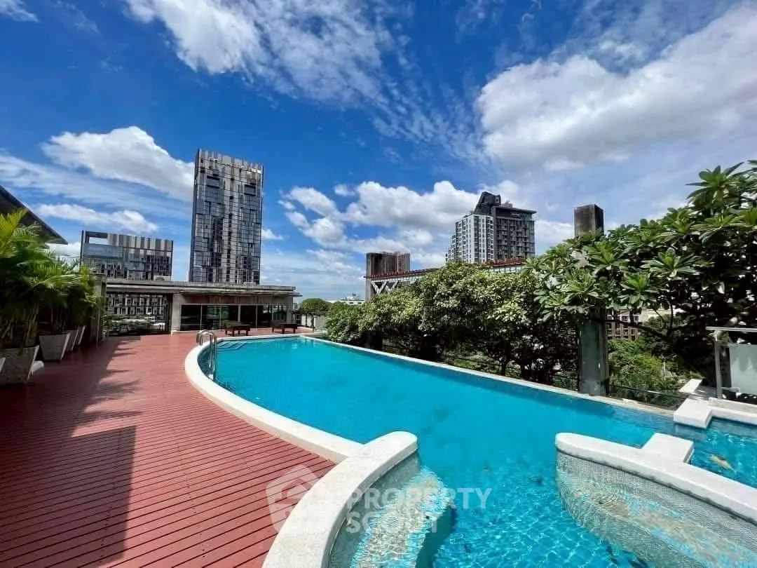 Luxurious rooftop pool with stunning city views and lush greenery, perfect for relaxation and leisure.