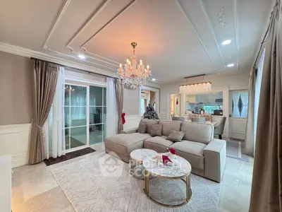 Luxurious living room with elegant chandelier and spacious seating area